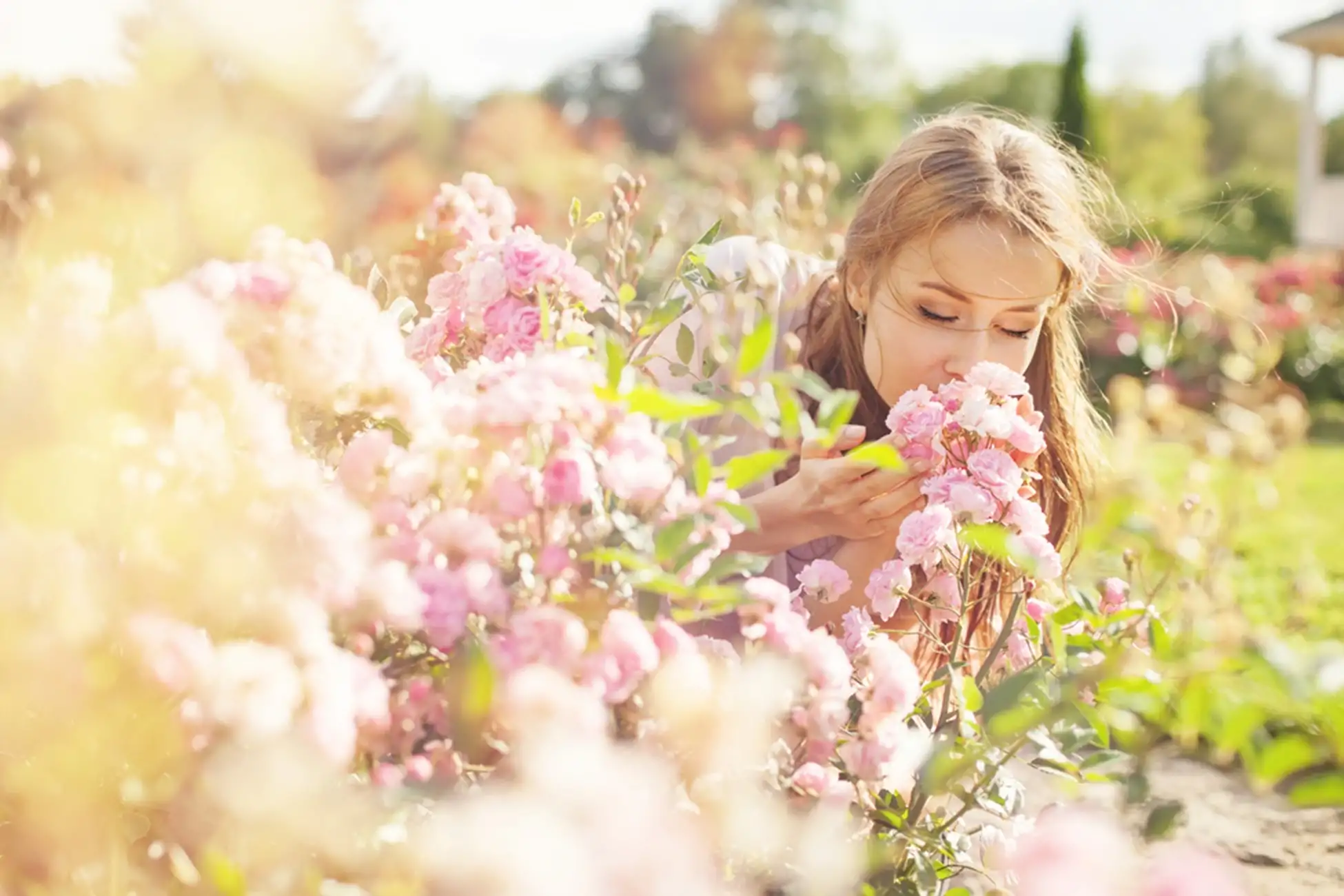 young women smelling at flowers